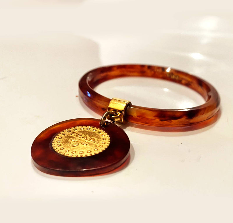 1990s Prada Resin Brown Bangle with Hanging Gold Metal Medallion